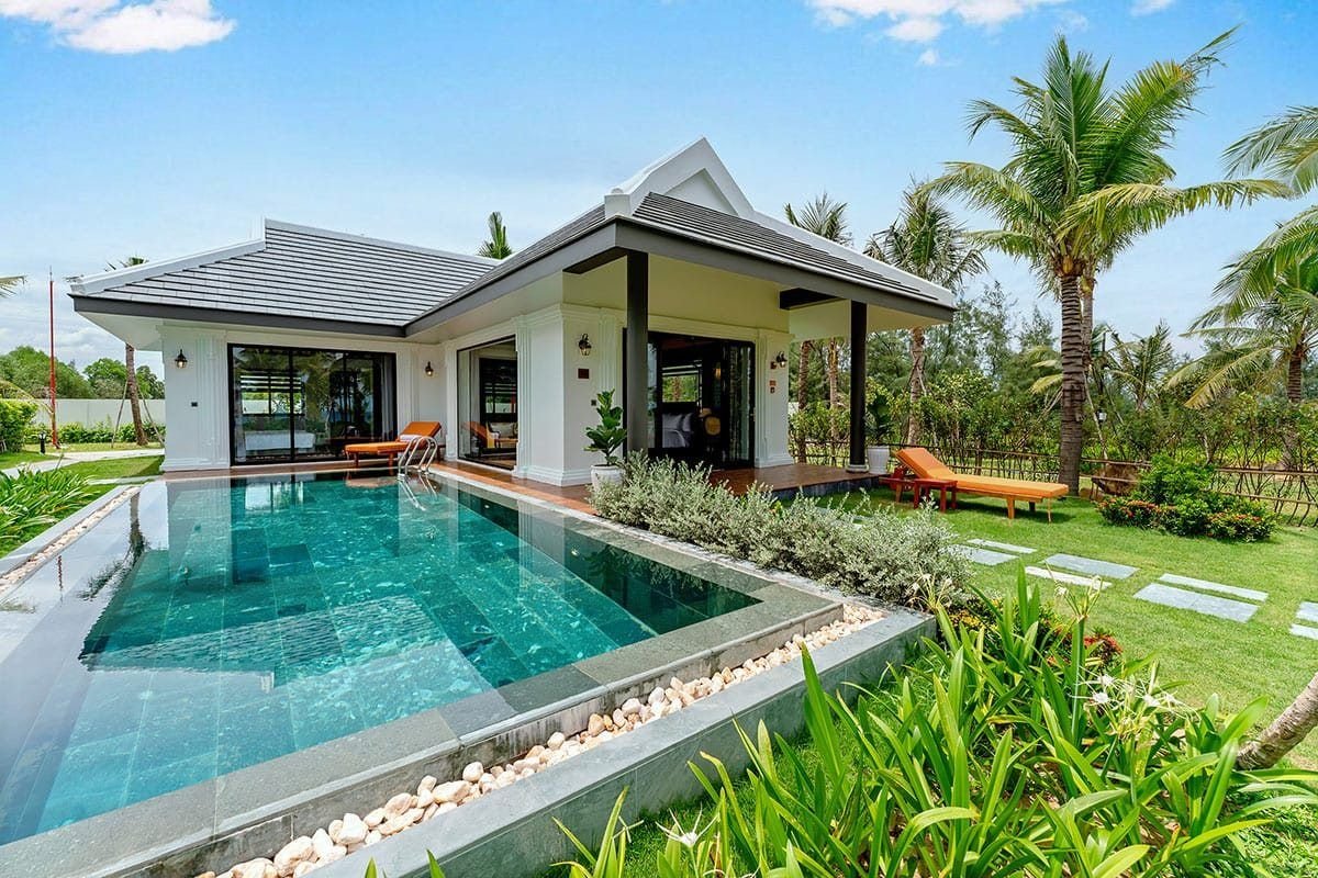 Private pool villa among palm trees at a beach resort in Vietnam